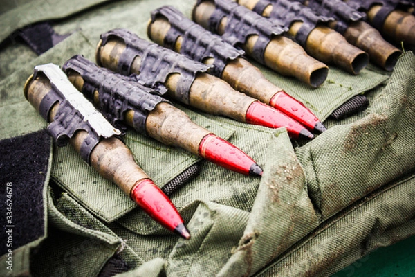 Fototapeta Ammunition. Loaded bullets and empty shells. War