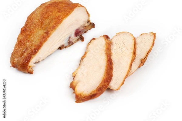 Fototapeta A close up of grilled, sliced chicken breast isolated on white background .