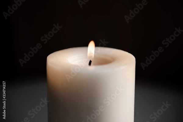 Obraz big white candle on a dark background