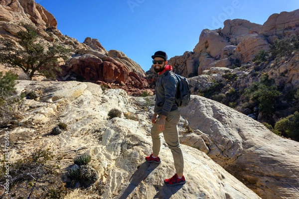 Obraz smiling man tourist backpacker in red rock mountains landscape Red Rock Canyon National Conservation Area Nevada’s Mojave Desert