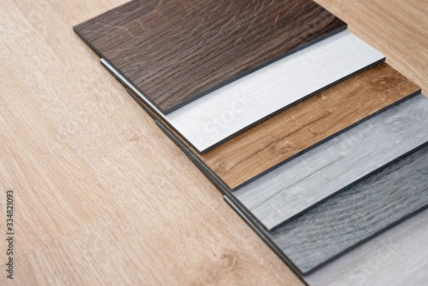 Fototapeta Sample catalog of luxury vinyl floor tiles with a new interior design for a house or floor on a light wooden background. Copy space.