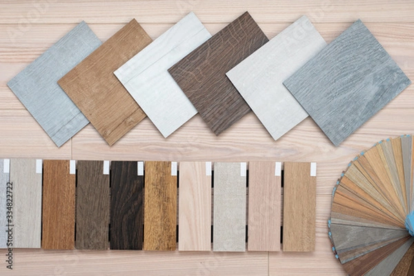 Fototapeta An example of a catalog of luxury vinyl floor tiles and a designer palette with textures with a new interior design for a house or floor on a light wooden background.