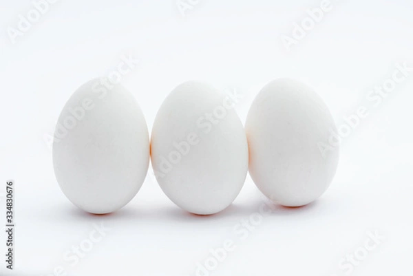 Fototapeta three white eggs isolated on white