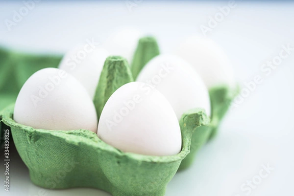 Obraz Green Paper Egg Box with white egg on white background