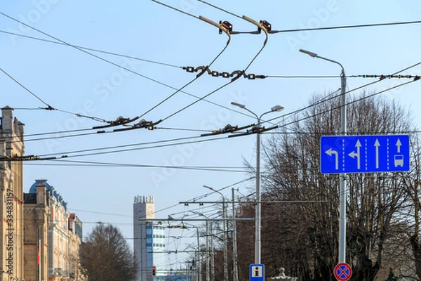 Fototapeta Traffic signs and electricity lines for trolleybuses, public transport in Riga, capital of Latvia