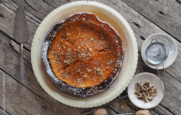 Obraz Pumpkin Background. Baked pumpkin sprinkled with ground walnuts, on a wooden ancient background with ingredients. Place for text.