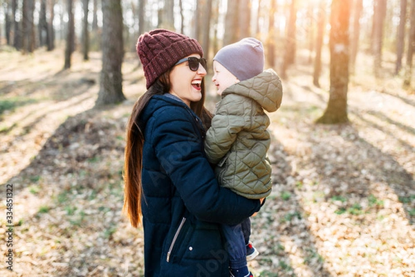Fototapeta Mother and baby son spend time outdoors together