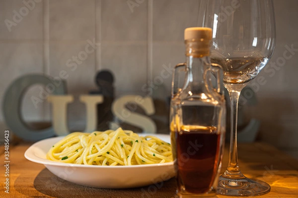Fototapeta  spaghetti with Cetara anchovy sauce. with glass of white wine