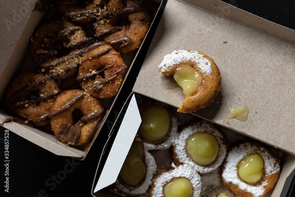 Obraz Mini doughnuts with custard and chocolate sauce and nuts