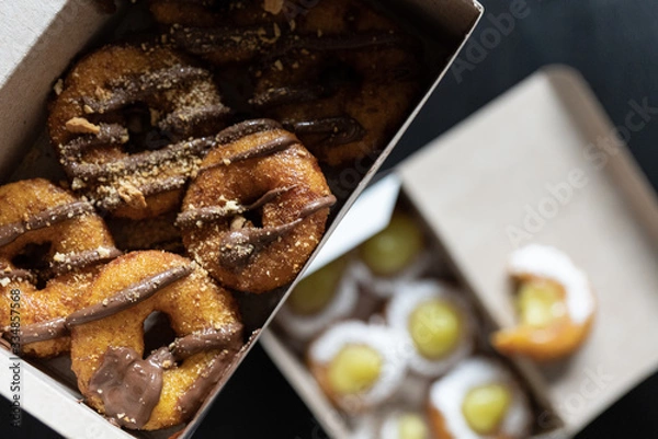 Obraz Mini doughnuts with custard and chocolate sauce and nuts