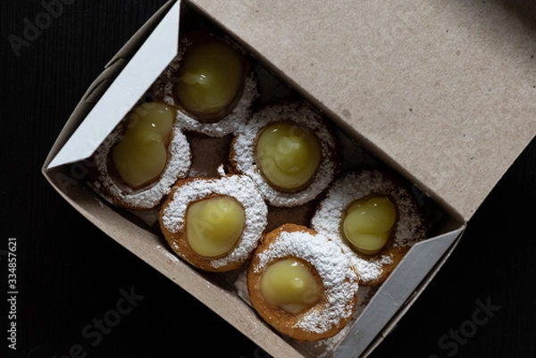 Obraz Mini doughnuts with custard and chocolate sauce and nuts