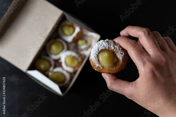 Obraz Mini doughnuts with custard and chocolate sauce and nuts
