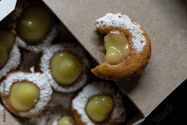 Obraz Mini doughnuts with custard and chocolate sauce and nuts