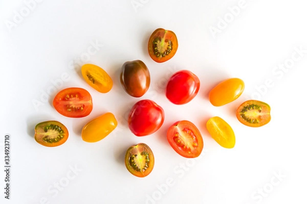 Fototapeta various colorful tomatoes isolated on white background. Top view, flat lay. Creative layout