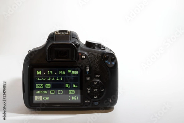 Fototapeta One black camera isolated on white background. Back view