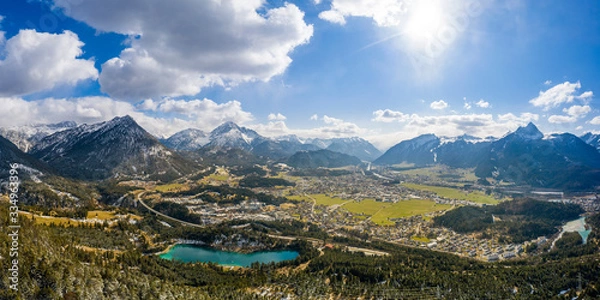 Obraz Panorama of circular deep valley basin of Reutte and Breitenwang with lake Urisee at sunny spring day