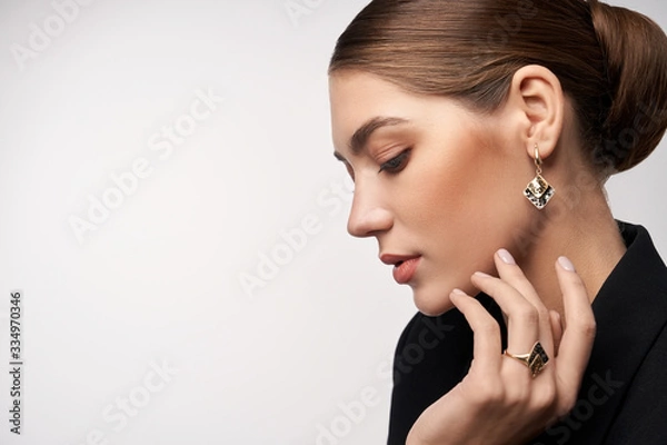 Fototapeta Model demonstrating earrings and ring.
