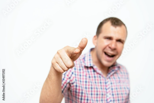 Fototapeta Young man showing his index finger towards the camera