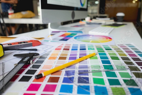 Fototapeta Engineers and creative artists work on table, work, consult, advise on choosing colors and materials, measuring size, choosing cool colors, soft tones, beautiful tones.