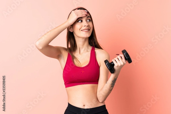 Fototapeta Young sport woman making weightlifting over isolated pink background has realized something and intending the solution