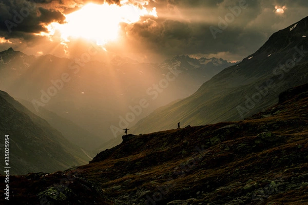 Fototapeta Wanderers enjoying the sunset at the Timmelsjoch
