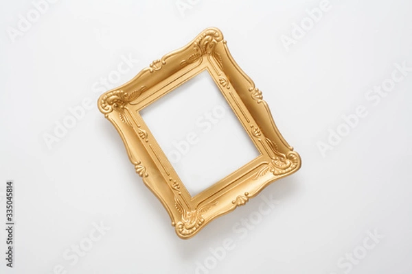 Fototapeta Gold photo frame in vintage style, located on a white background. A conceptual frame for registration of certificates, awards and diplomas, or a stylish design of any subject.