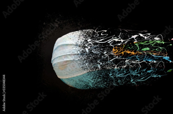Fototapeta Globe of the planet Earth in a medical mask dissolves into small particles on a black background. The concept of a coronavirus, the end of the world, a pandemic, absorption, extinction.