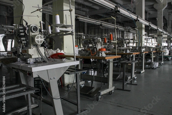 Obraz sewing machine in a large sewing shop, factory