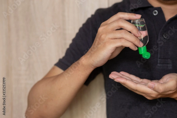 Obraz using hand sanitizer gel cleaning hands at home