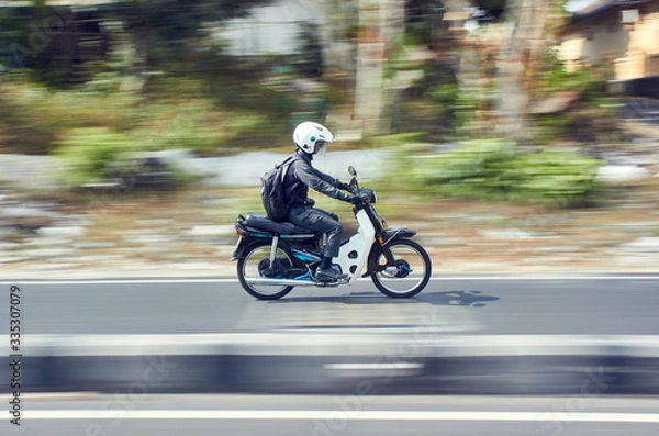 Fototapeta Fast moving moped with panning technique