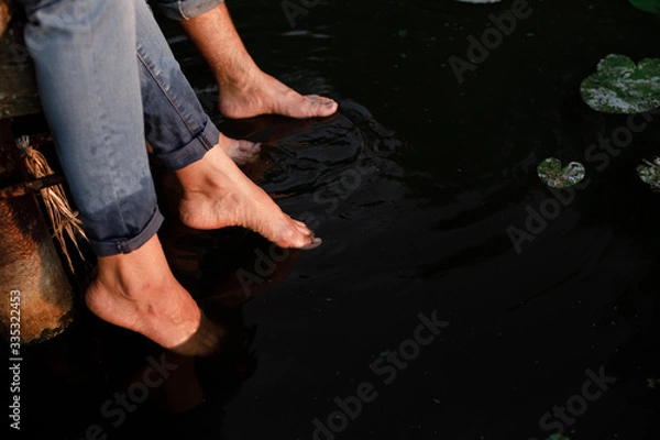 Fototapeta Happy couple running in shallow water. Summertime. loving couple is playing in the water. selective focus