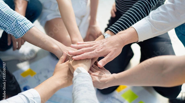 Fototapeta Background of business people bare hands stack join together in the middle with natural sunlight, Concept power of social network charity or volunteer to be unity help and support community.