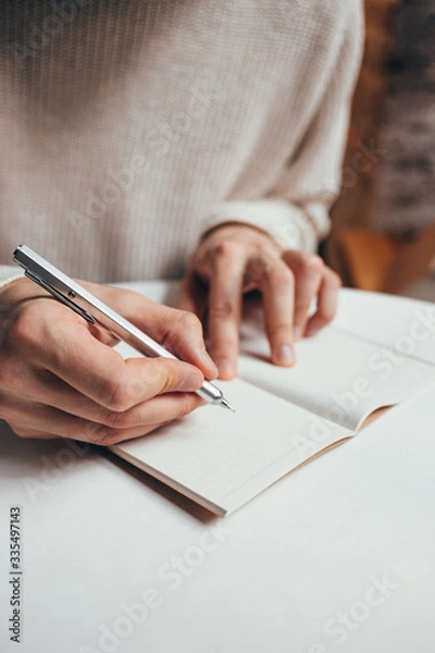 Obraz man writing a notes in notebook