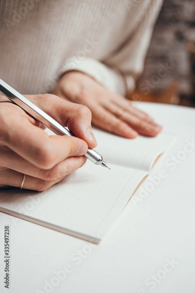 Obraz man writing a notes in notebook