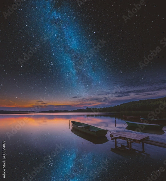 Obraz Surreal lake with boats under starry sky