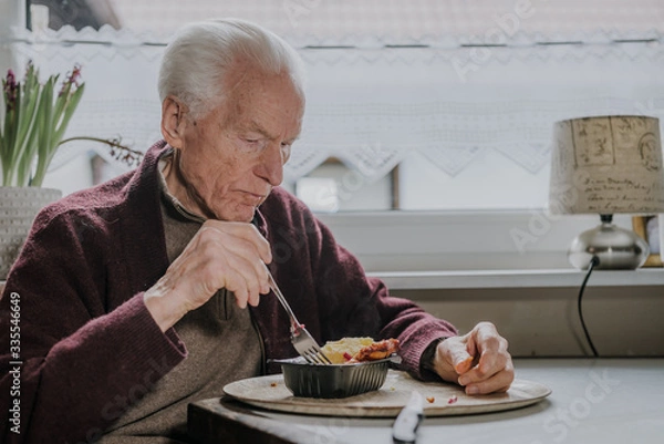 Obraz Single senior eats dinner at home