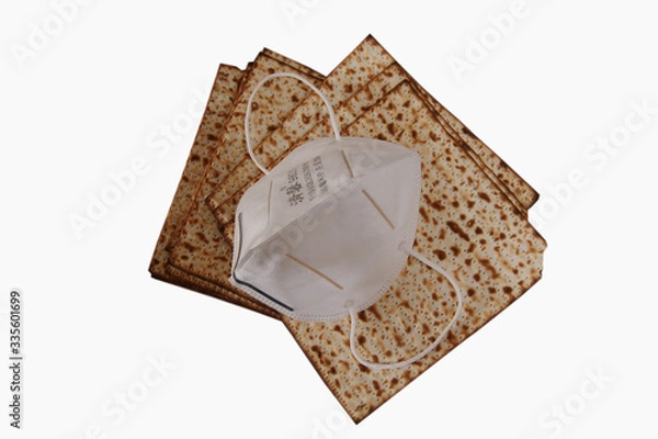 Obraz Matzah - Traditional Jewish food for Passover is covered in a mask against the Corona virus.