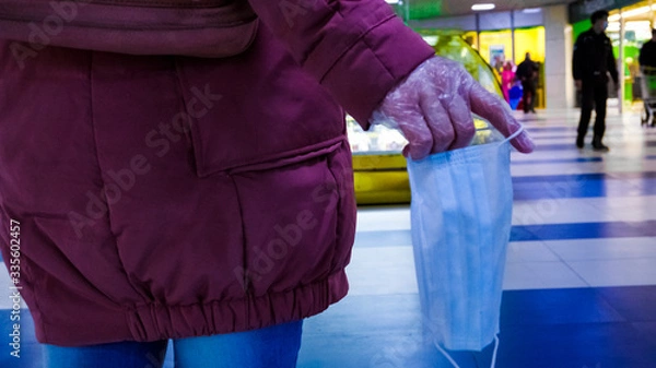 Obraz the girl has a protective mask in her hand