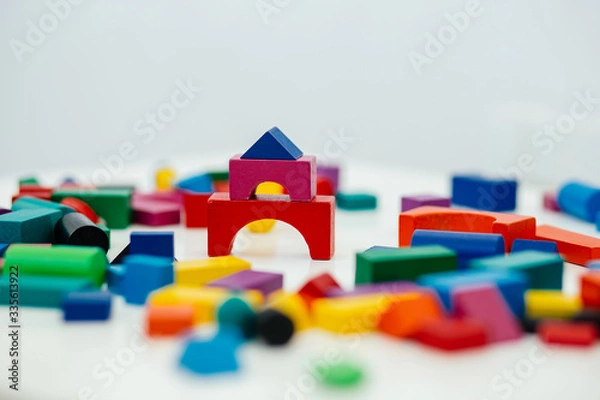 Fototapeta Multi-colored blocks of a wooden constructor. Concept of development of preschool children.
