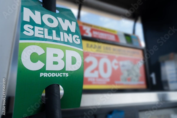 Fototapeta Closeup of CBD product sign at a gas station