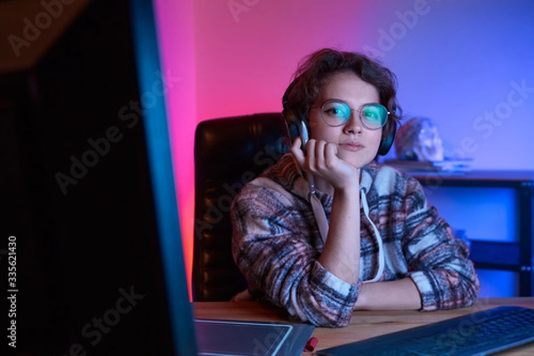 Fototapeta Freelancer desinger working from home using graphic tablet and stylus with neon light at the back