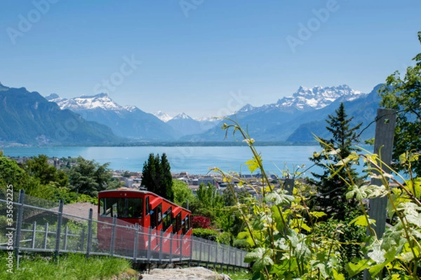 Fototapeta Red cable car on the top of mountain with the view on Lake Geneva and Alps mountains