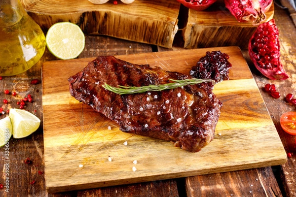 Obraz rib eye steak with margarine on a cutting Board