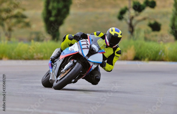 Obraz Motorcycle practice leaning into a fast corner on track