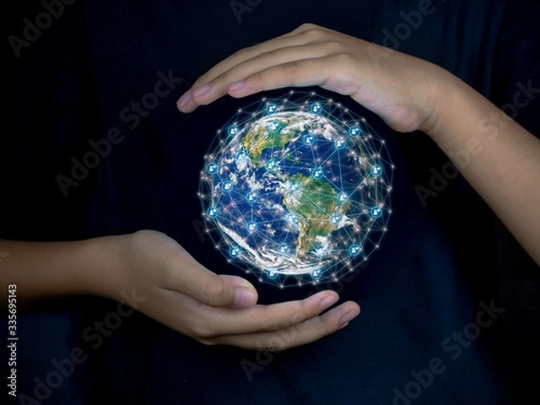Fototapeta Earth was holding in human hands with communication network, IOT and blockchain on globe on black background. Earth day. Energy saving concept, This image furnished by NASA.