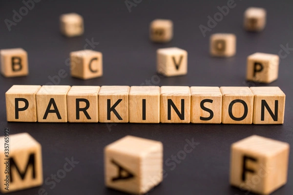 Fototapeta Parkinson - word from wooden blocks with letters, parkinson disease of the nervous system concept, random letters around black background