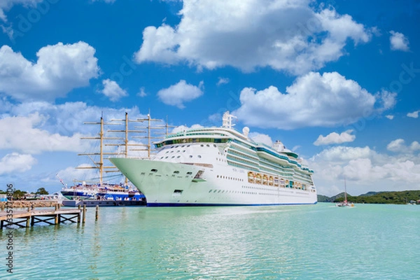 Fototapeta White Cruise Ship by Wood Masts with tourists