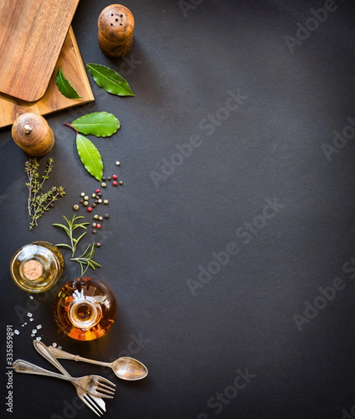 Obraz Background for the menu. Wooden board, antique cutlery, condiments and olive oil. Copy space.