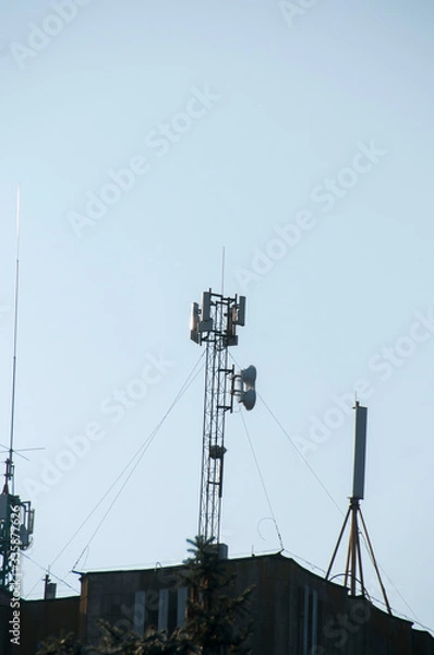 Obraz Cell tower closeup against a white sky.