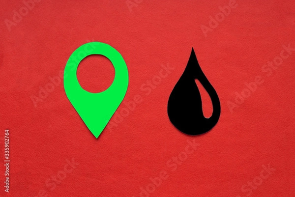 Fototapeta The geolocation sign is green, with a drop of oil on a red background. Oil and petroleum products market.
